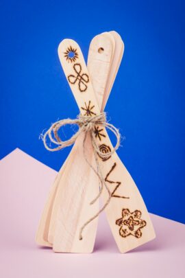 Puidust pannilabidad seismas, kus esimesele labidale on põletatud erinevad mustrid.